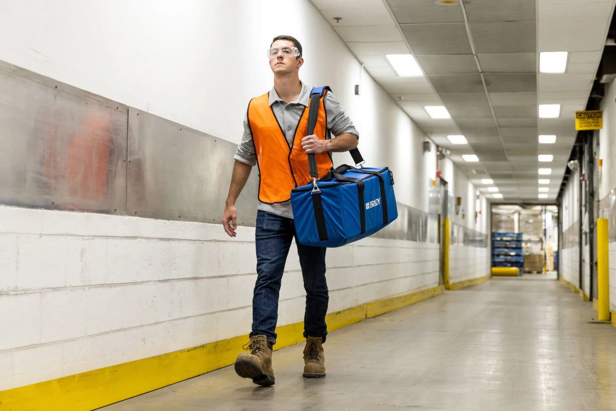 Worker carrying the Brady i4311 soft carry case over his shoulder