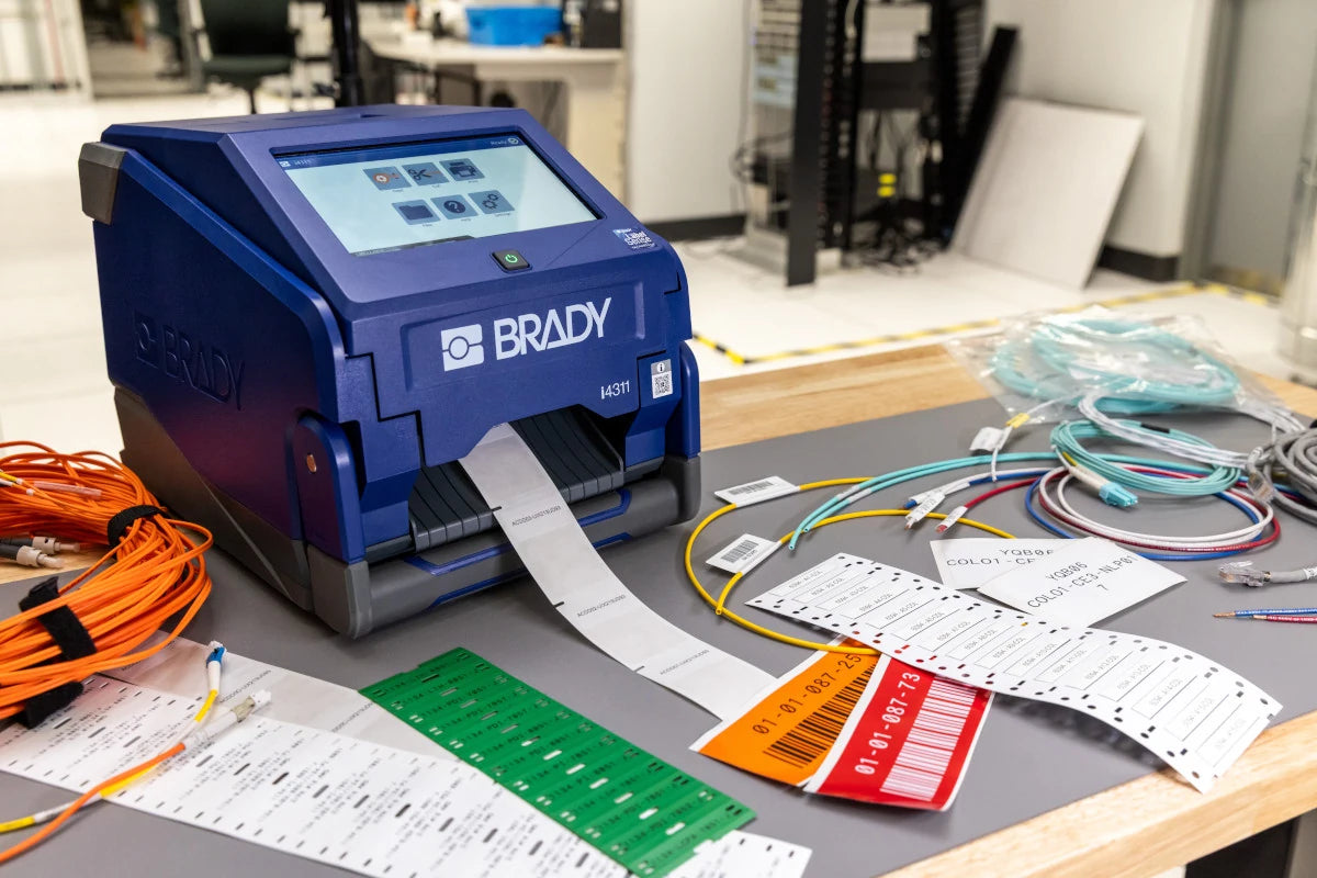 Brady i4311 producing labels beside wire markers, cable labels and coloured identification materials
