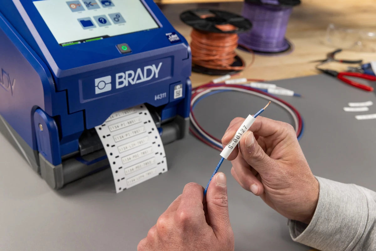Applying a printed wire marker beside the Brady i4311 at a workbench